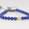 BEADED PULL BRACELET WITH BLUE LAPIS AND GOLD SKULL DETAIL